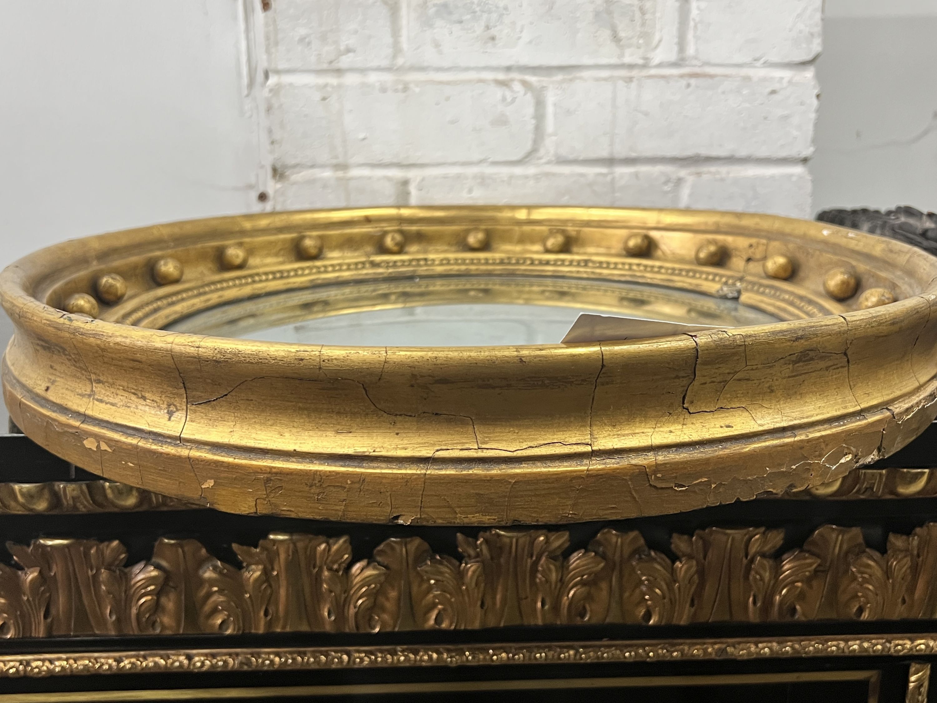 A Regency mahogany circular gilt framed convex wall mirror, diameter 49cm